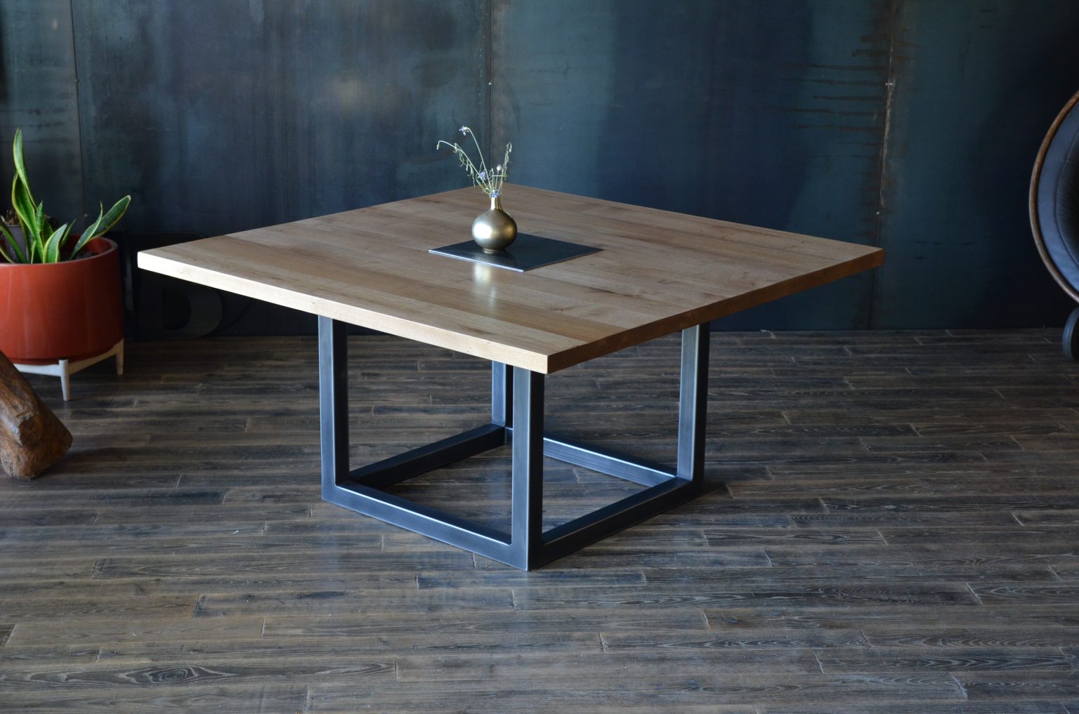 Vue d’ensemble de la table carrée CALLISTA en bois massif et métal noir, idéale pour 8 personnes.